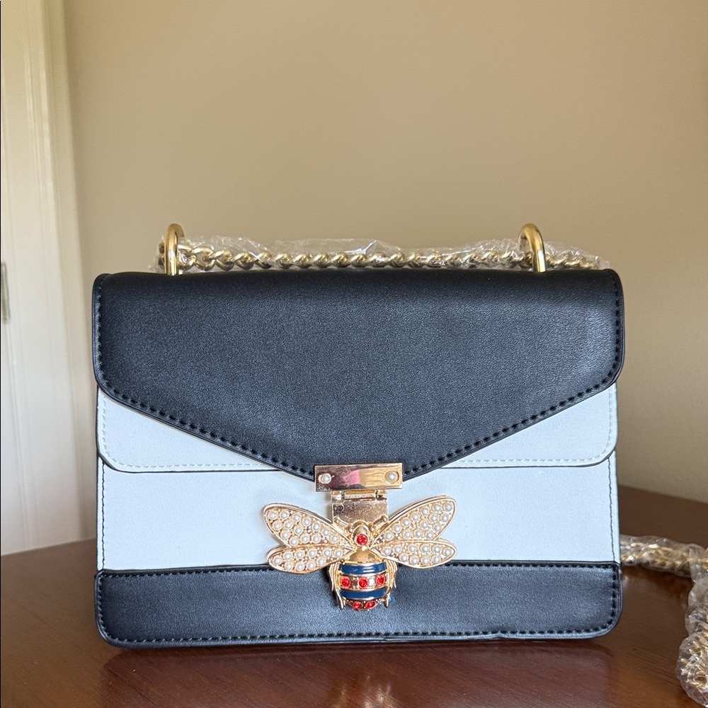 Elegant Black and White Handbag with Gold Bee Accent